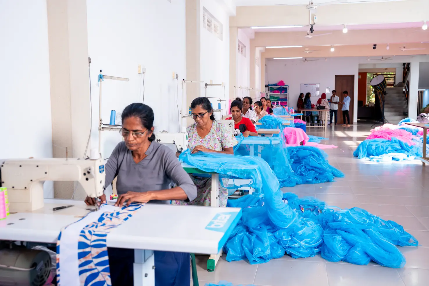 Machinists at work along the sewing floor of the Hero Mosquito Nets factory in Dickwella